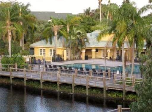 back of property featuring a water view