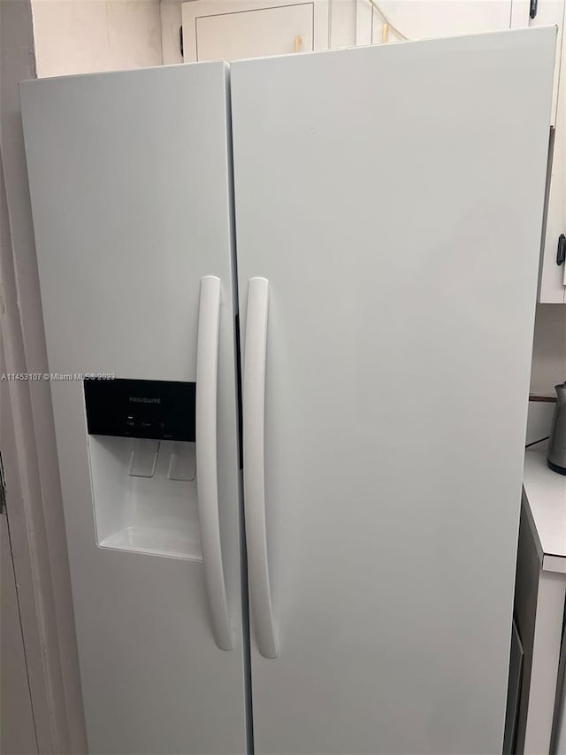 interior details with white refrigerator with ice dispenser