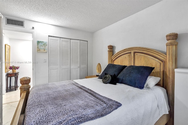 tiled bedroom featuring a textured ceiling and a closet