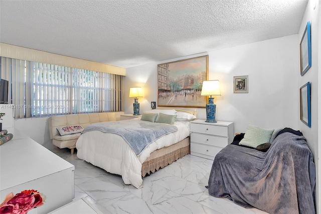 bedroom featuring light tile floors and a textured ceiling