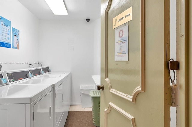 washroom featuring light tile floors and washing machine and dryer