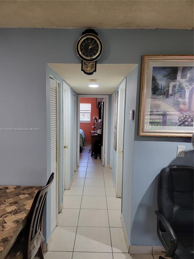 hall featuring light tile flooring