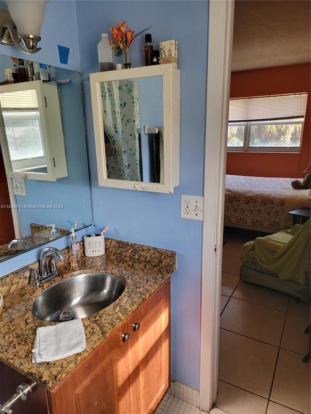 bathroom with vanity with extensive cabinet space and tile floors