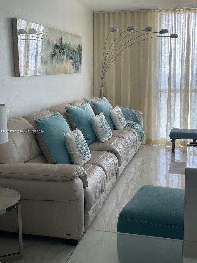 tiled living room featuring a healthy amount of sunlight