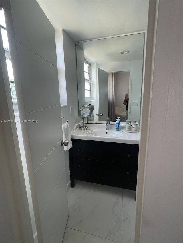 bathroom with tile flooring and vanity