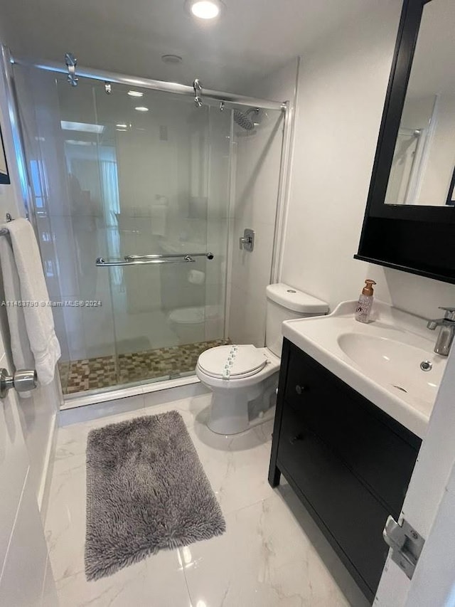 bathroom featuring toilet, tile floors, large vanity, and an enclosed shower