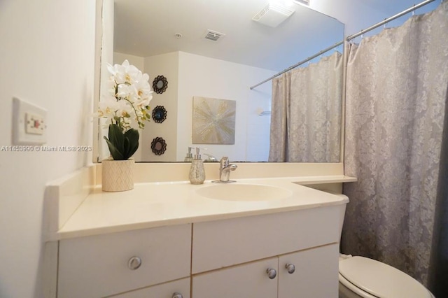 bathroom featuring oversized vanity and toilet