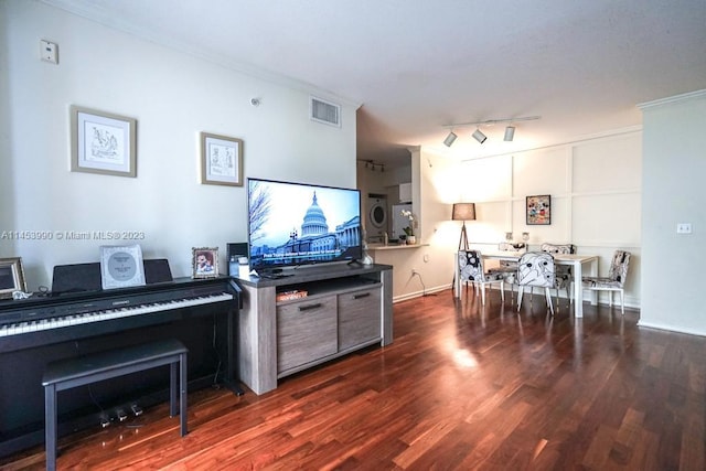 miscellaneous room with rail lighting and dark hardwood / wood-style flooring