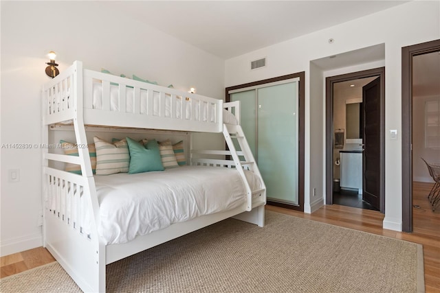 bedroom with wood-type flooring and a closet