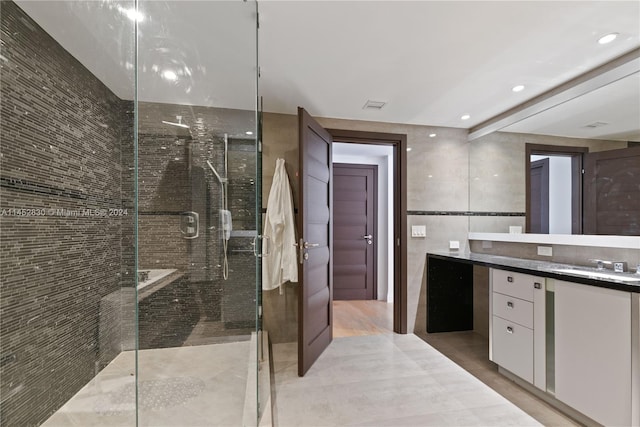 bathroom featuring an enclosed shower and vanity