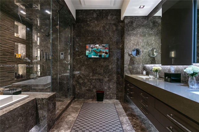 bathroom with tile walls, vanity, and separate shower and tub