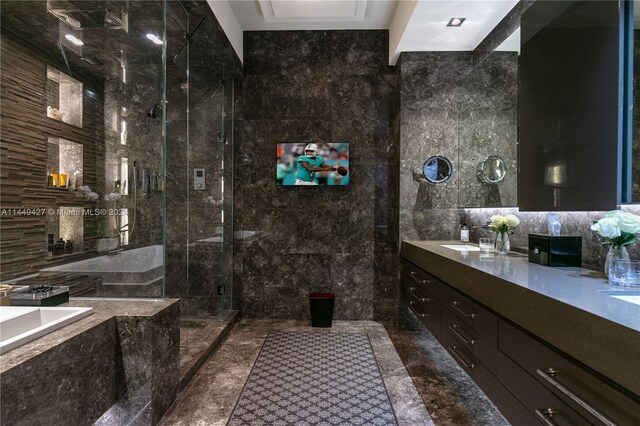 9705 Collins Ave Unit 1803N, Bal Harbour, FL 33154 - bathroom featuring tile walls, marble tiled flooring, double vanity, a garden tub, and a shower with door