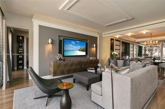 living room with wood-type flooring and a chandelier