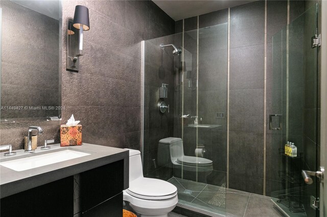 9705 Collins Ave Unit 1803N, Bal Harbour, FL 33154 - full bath featuring toilet, vanity, a stall shower, and tile walls