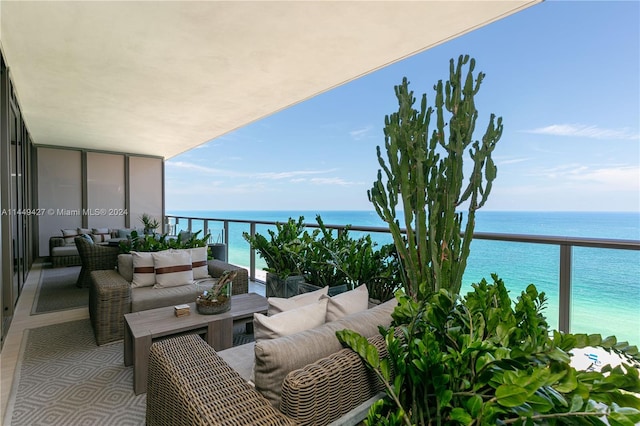 balcony featuring a water view and an outdoor living space