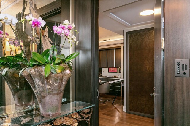 9705 Collins Ave Unit 1803N, Bal Harbour, FL 33154 - corridor with a tray ceiling and wood finished floors