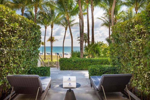 view of patio / terrace featuring a beach view and a water view