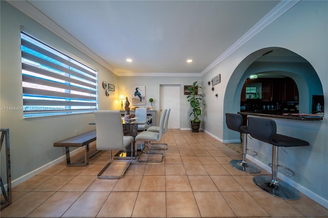 dining space featuring ornamental molding and light tile flooring