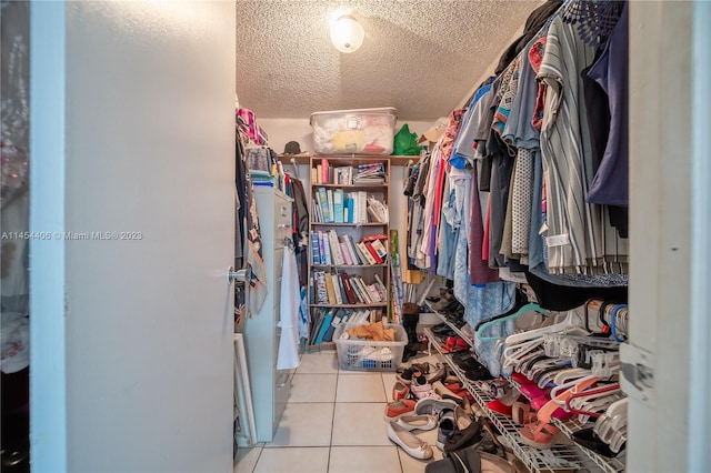 spacious closet with light tile flooring