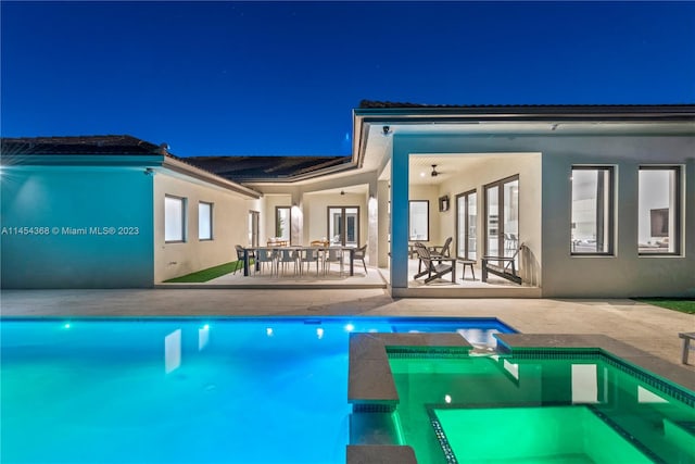 exterior space featuring an in ground hot tub, french doors, and a patio area