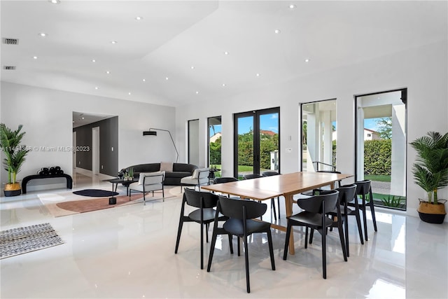 tiled dining space featuring french doors