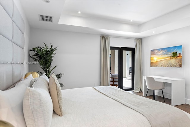 bedroom featuring french doors and dark hardwood / wood-style flooring