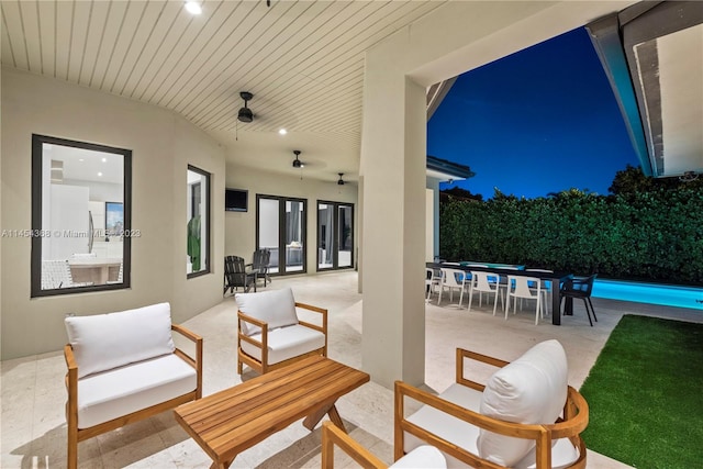 view of patio featuring outdoor lounge area, a fenced in pool, and ceiling fan