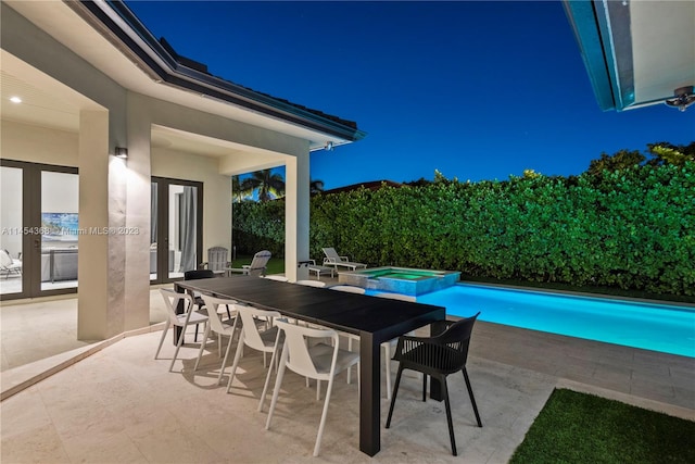 view of patio featuring a swimming pool with hot tub