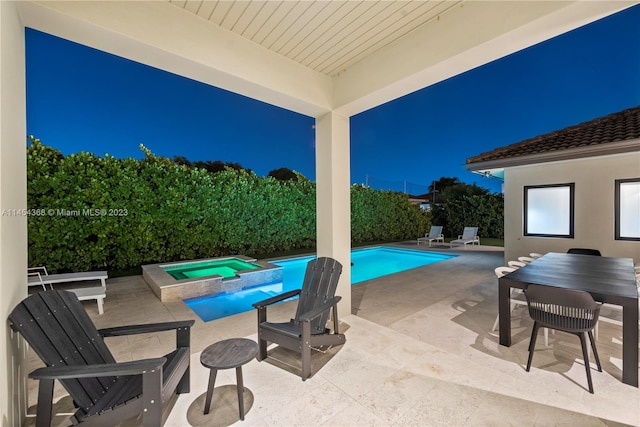 view of terrace featuring a swimming pool with hot tub