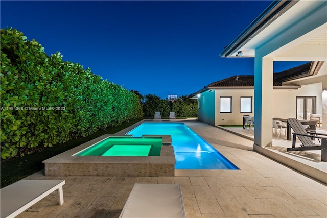 view of swimming pool with an in ground hot tub and a patio