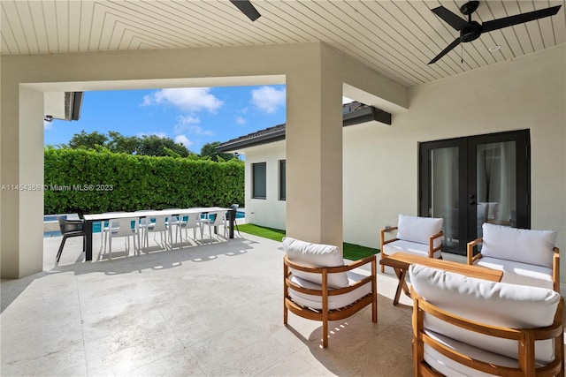 view of patio / terrace featuring french doors, outdoor lounge area, ceiling fan, and a fenced in pool