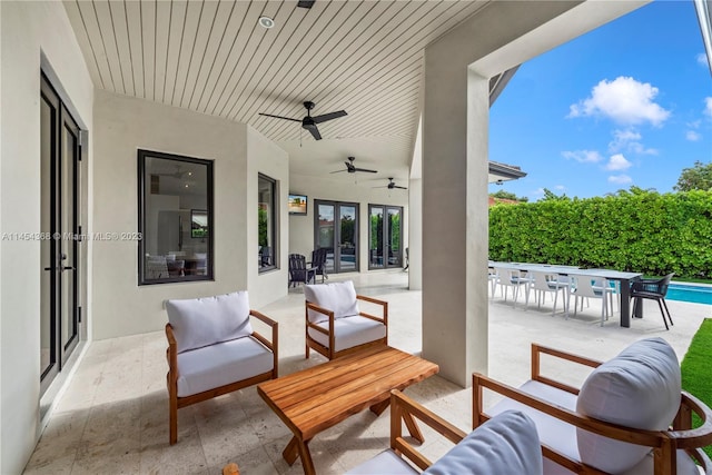 view of terrace with french doors, an outdoor living space, ceiling fan, and a fenced in pool