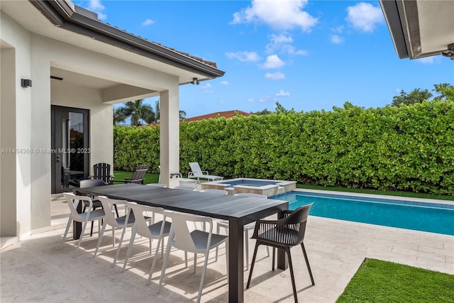 view of terrace with a pool with hot tub