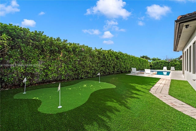 view of yard featuring a fenced in pool and a patio area