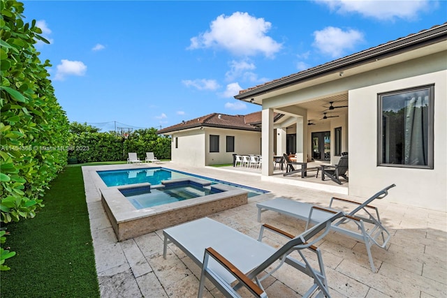 view of swimming pool featuring an in ground hot tub, ceiling fan, and a patio area