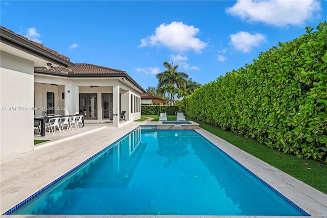 view of pool with a patio and ceiling fan