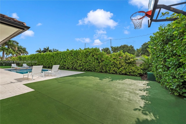 view of yard with a fenced in pool and a patio