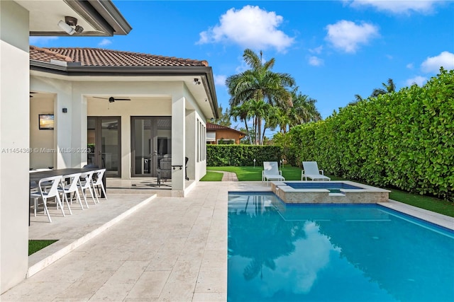 view of swimming pool featuring an in ground hot tub, ceiling fan, and a patio