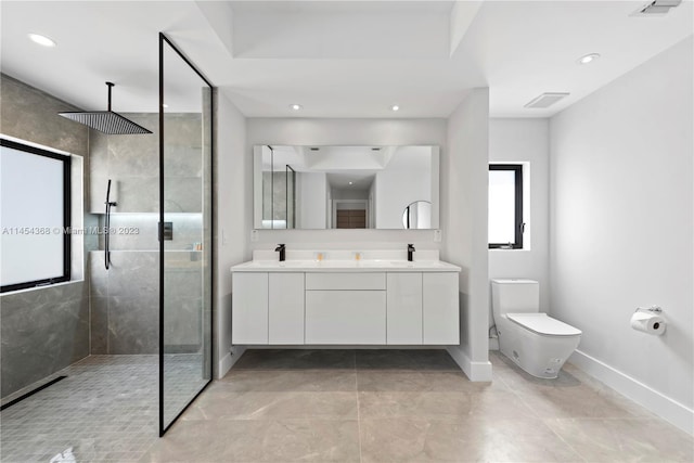 bathroom featuring toilet, double vanity, tile floors, and a shower with shower door