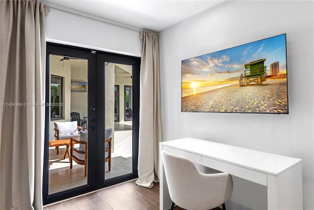 office with french doors and hardwood / wood-style flooring