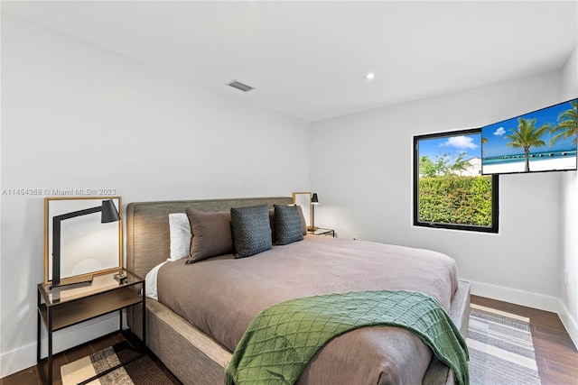 bedroom with dark hardwood / wood-style floors