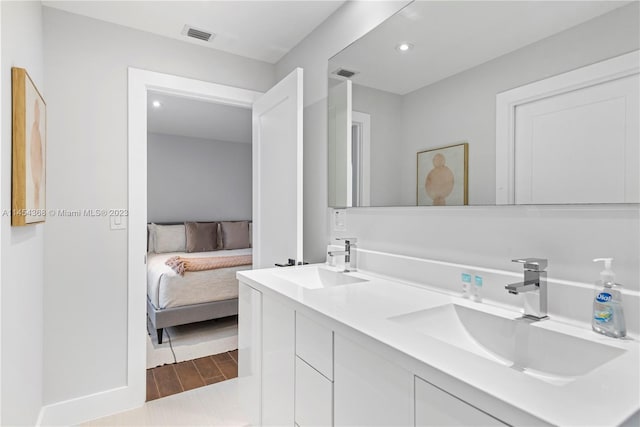 bathroom featuring double sink vanity and wood-type flooring