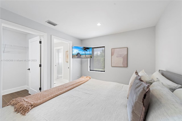 bedroom with a closet and dark wood-type flooring