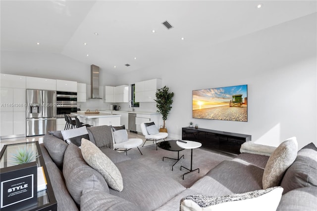 living room with high vaulted ceiling, a fireplace, and sink