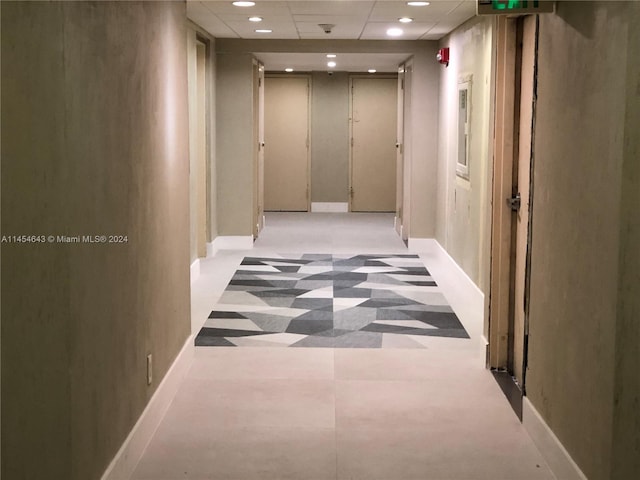 hallway with a drop ceiling