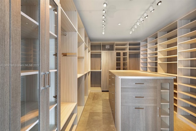 walk in closet featuring light tile flooring