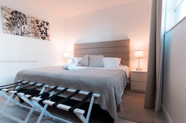 bedroom with light carpet and a textured ceiling