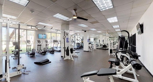 exercise room featuring a paneled ceiling and ceiling fan