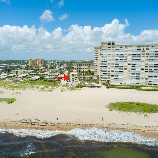 drone / aerial view featuring a view of the beach and a water view