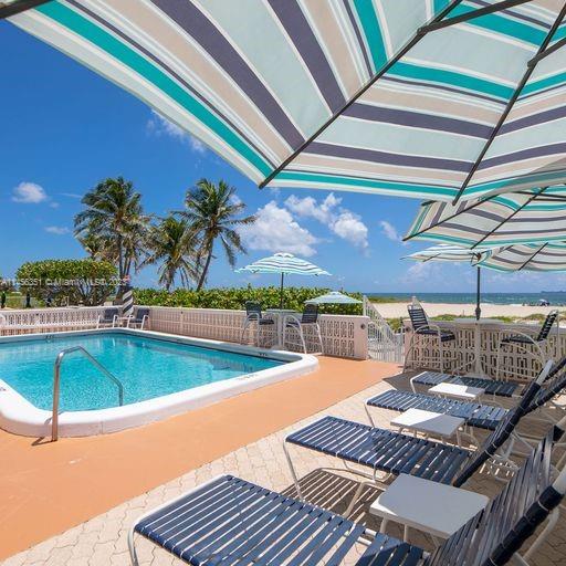 view of swimming pool featuring a patio and pool water feature